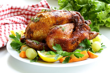 roasted chicken with herbs served on a plate with vegetables