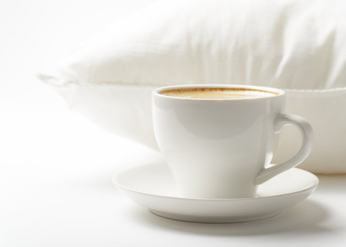 Cup of coffee and white pillow