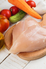 Fresh chicken on wooden table