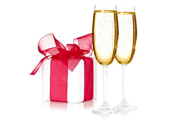 Glasses of champagne and a gift box