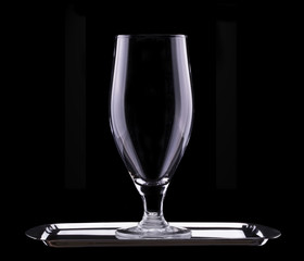 empty glass of light beer on black background