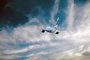 Airplane at fly on the sky with clouds