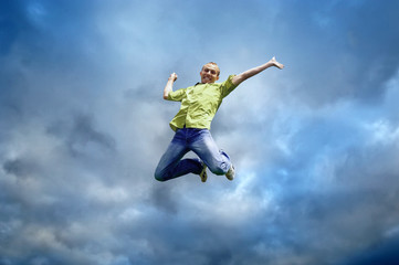 Plakat Jump of man under sky with clouds