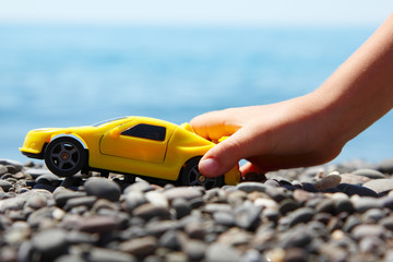 boy play with a car summer beach outdoor