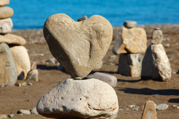 group of balanced stones with rock's heart at front view, pebble