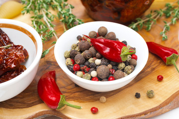 Assorted hot peppers in a bowl and fresh chili peppers