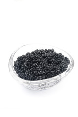 Fototapeta na wymiar black caviar in a glass bowl isolated