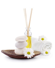 spa decoration with stones, daisies and masssage oil
