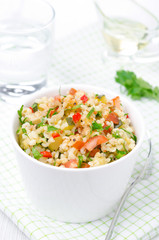 bowl of salad with bulgur, zucchini, tomatoes, chili peppers