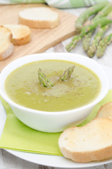 cream soup of asparagus and green peas with toasted bread