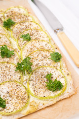pie with zucchini and herbs, vertical, selective focus