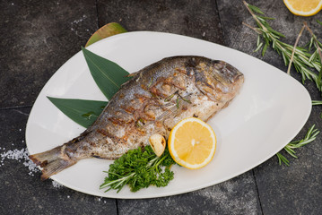 fresh fish cooked on the grill served on a platter