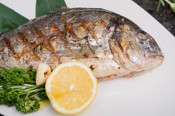 fresh fish cooked on the grill served on a platter