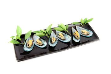 The Seafood of Mussels in a black dish.