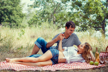 young couple have a rest on picnic, holding hands
