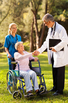 male doctor greeting senior patient