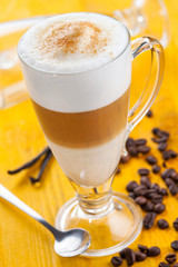 Coffee latte on yellow background