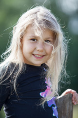 Closeup portrait of happy small Caucasian girl with wild hair