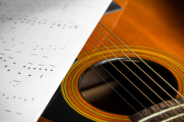 Acoustic guitar with song note paper