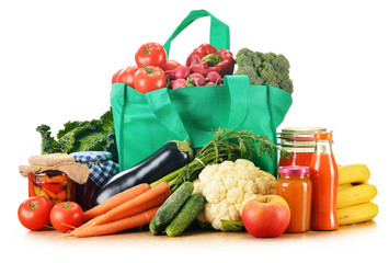 Green shopping bag with assorted grocery products isolated