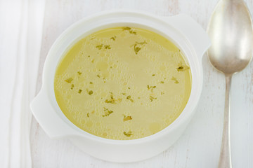 chicken broth in white bowl