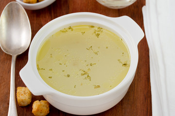 chicken broth in bowl and spoon