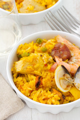 rice with seafood and meat in white dish