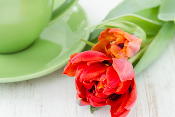 green teacup with tulips
