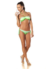 Naklejka premium pretty and beautiful young brunette posing in a bikini