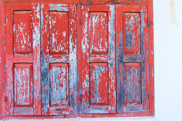 Red wooden window with white wall