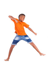 Portrait of a cute teenage black boy jumping over white backgrou