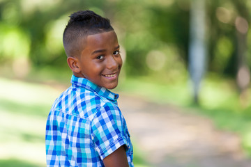 Outdoor portrait of a cute teenage black boy - African people