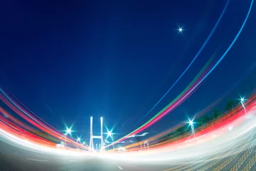 Acrylic prints Highway at night cars light trails on the modern bridge at dusk
