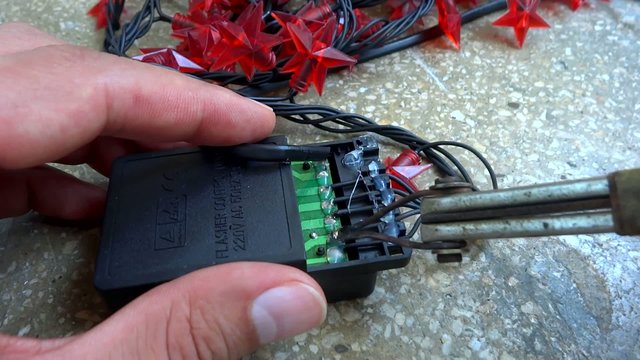 person repairing flasher controller