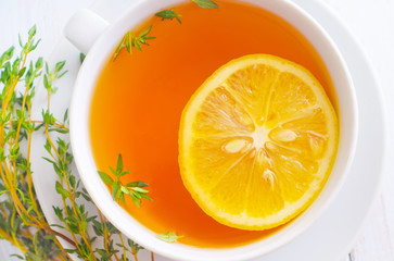 Fresh tea with lemon in the white cup