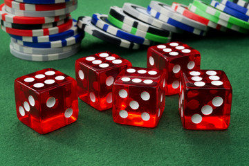 Red dice and chips on a green felt