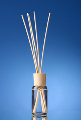 Bottle of air freshener on blue background