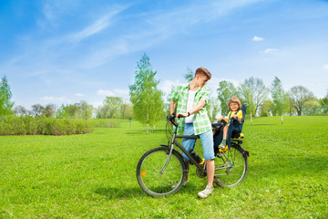 Fototapeta premium Man with child on the bike