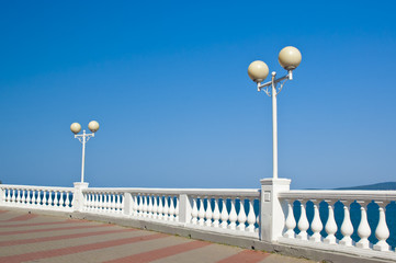 Lantern and balustrade on sea shore