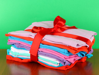 Pile of clothing with red ribbon and bow