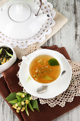 Cup of tea with linden on napkins on    wooden table