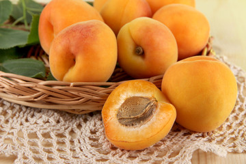 Apricots on wicker coasters on napkin on  wooden table