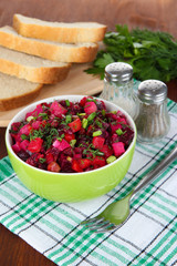 Beet salad in bowl on table close-up