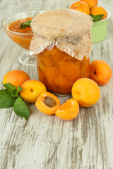 Apricot jam in glass jar and fresh apricots,