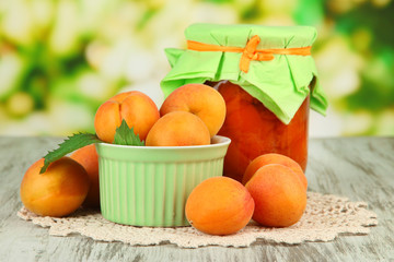 Apricot jam in glass jar and fresh apricots,