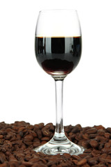 Glass of liquor and coffee grains, isolated on white