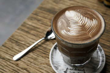 hot mocha with latte art on wooden table