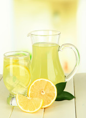 Delicious lemonade on table on light background