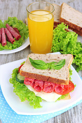 Composition with fruit juice and tasty sandwich with salami