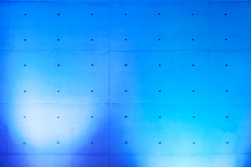 Concrete wall with blue spotlights